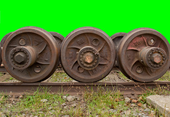 Old spare railway wheels on the axle in a repair workshop. Hromakey