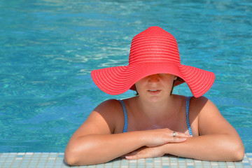 Real female beauty relaxing in swimming pool