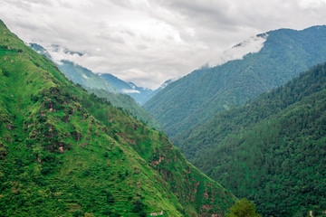 Fototapeta na wymiar mountain range view. Timelapse Of Moving Clouds And Fog over Himalayan mountain range in Sainj