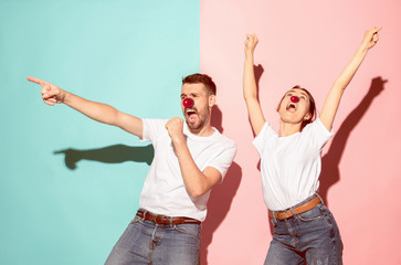The happy surprised and smiling man and woman at red nose day. The clown, fun, party, celebration,...