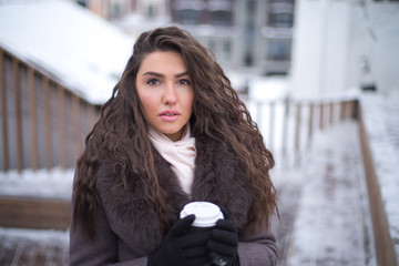 girl in a coat with coffee