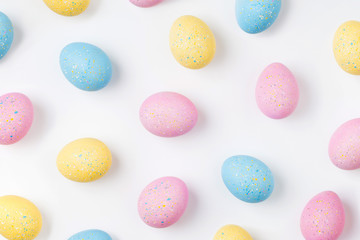 Fototapeta na wymiar Background with pale pink, blue, yellow Easter eggs. Compositions in pastel colors. Easter concept
