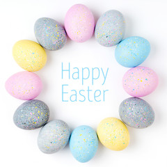 Stylish Frame of pale pink, blue and gray Easter eggs with copy space for text. Flat lay