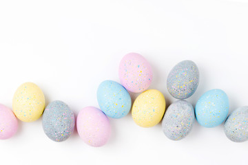 Background with pale pink, blue, yellow and gray Easter eggs. Compositions in pastel colors.  Easter concept