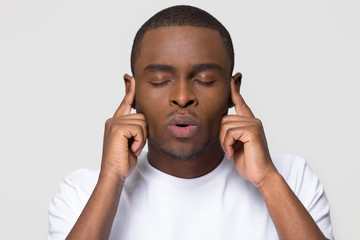 Stressed nervous african american man breathing out for stress relief, tired black guy massaging...
