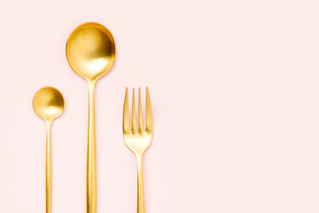 Pattern made of cutlery on pastel background, flat lay, top view. Minimalist concept.