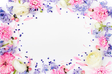 Obraz na płótnie Canvas Beautiful floral arrangements. Frame made of ranunculus, chrysanthemum and other flowers on white background. Flat lay, top view.