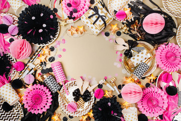 Party decoration background. Gold, black and pink color. Flat lay, top view