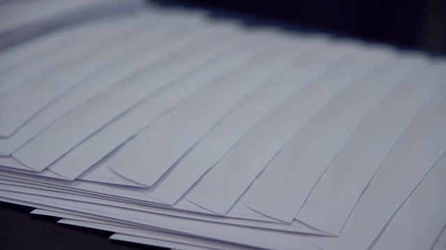 a lot of white postal envelopes moving along the conveyor belt