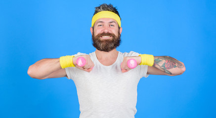 Sportsman retro outfit training blue background. Athlete on way to strong body. Healthy habits. Athlete amateur workout. Athlete training with little dumbbell. Man bearded athlete exercising dumbbell