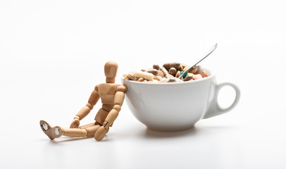 Vitamin cocktail. Health problem. Immunity care and medicine vitamins. Fast treatment. Mixing medicines. Take medicine concept. Medicines dose. Wooden human dummy near cup full pills and tablets