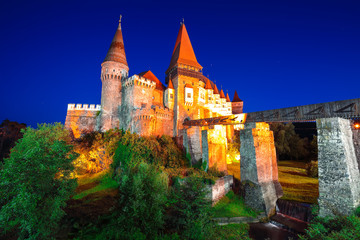 Beautiful night panorama of the Hunyad Castle / Corvin's Castle with wooden bridge.