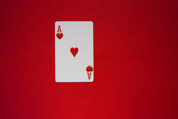  ace of hearts playing card with red plastic hearts . love is game concept