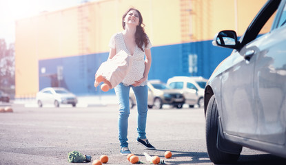 Fototapeta premium Girl with food coming out of the grocery store