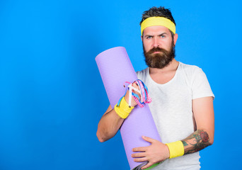 Athlete guide stay in shape. Man bearded athlete hold fitness mat and tape measure. Athlete professional coach motivated for training. Old school aerobics concept. Athlete wear bandages for sweat
