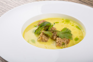 Yellow cream soup served with croutons
