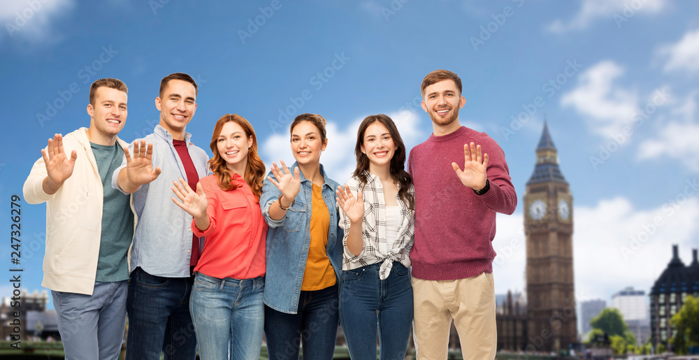 Sticker friendship and people concept - group of smiling friends waving hands over london city background