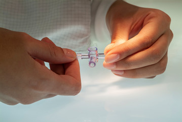 Medical plastic pipe T connector held in hands