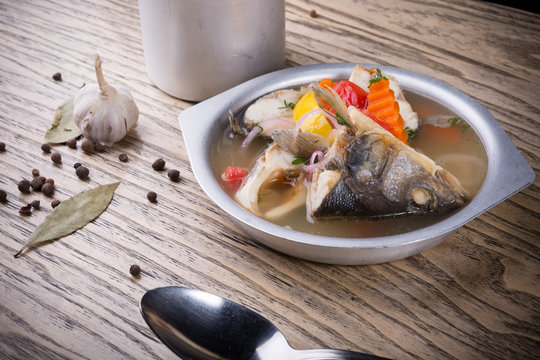 Rustic fish soup served in a metal dishware