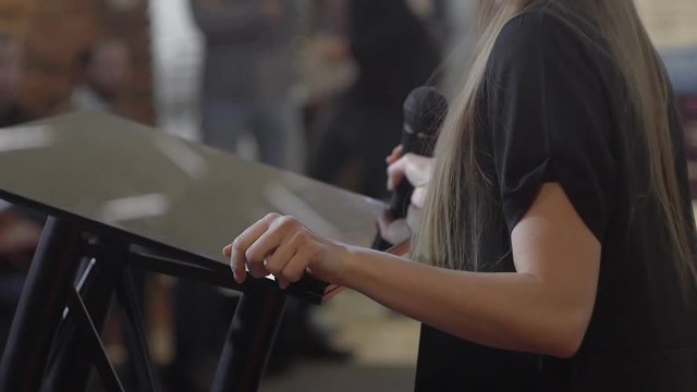 the girl with the microphone is nervous before the performance