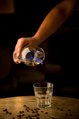 Bartender pouring burning absinthe