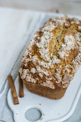 Banana Bread with cinnamon crumb coat on white wooden background close up selective focus