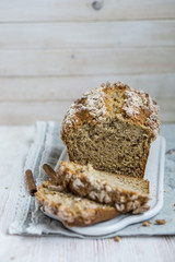 Banana Bread with cinnamon crumb coat on white wooden background close up selective focus