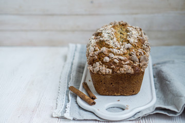 Banana Bread with cinnamon crumb coat on white wooden background close up selective focus