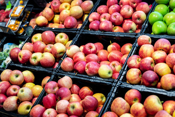 Grocery supermarket store. Shelves with variety of different orgnaic fresh ripe apples. Vegetable and fruit market