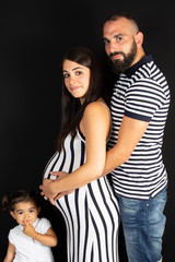pregnant mother lifestyle with daughter and father in black background