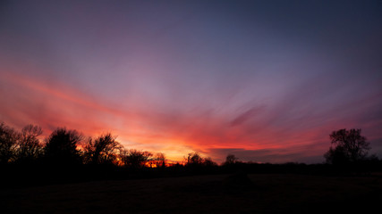 Fototapeta na wymiar Red sunset in a rural area