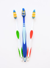 Flat lay composition with manual toothbrushes on white background.Toothbrush and toothpaste.op view, flat lay. Minimal concept, space for text.set of multicolored toothbrushes on white.