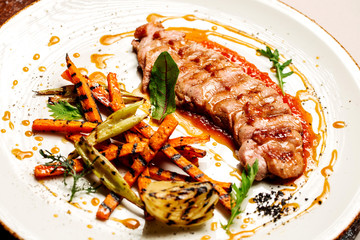 Delicious sliced grilled duck breast with fresh sauce.  closeup of professionally prepared food.