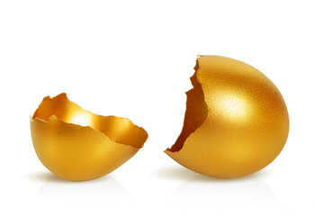 Golden cracked eggshell close-up. Macro. White background