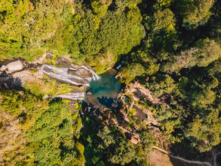 Waterfall with blue water in tropical jungle. Aerial drone view