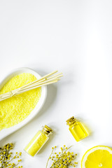 Cosmetic oil and sea sail for bath white background top view