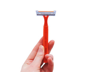 Razor in a man hand on a white background. Removal of unwanted hair. top view. Concept of using razor. Orange men's disposable razors. Shaving razor instrument.beauty, skin care concept 