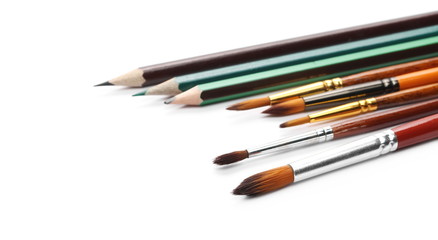 Paintbrushes and pencils isolated on white background