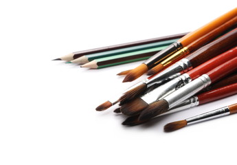 Paintbrushes and pencils isolated on white background