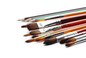 Paintbrushes and pencils isolated on white background