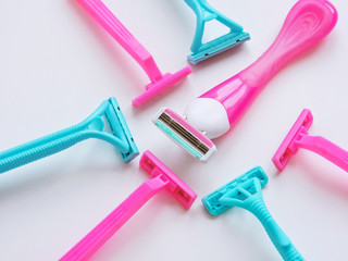 Removal of unwanted hair. top view. Concept of using razor. Shaving razor instrument. Skin care concept. Epilation hair removal. Flat lay, top view.multi-colored women's shaving razors isolated.