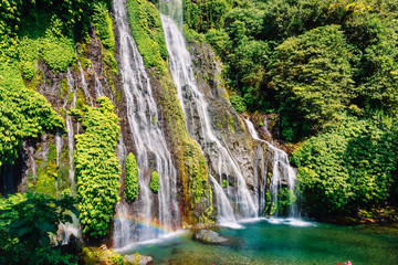 Fototapeta na wymiar Waterfall with blue water and rainbow in tropical island. Bali, Indonesia