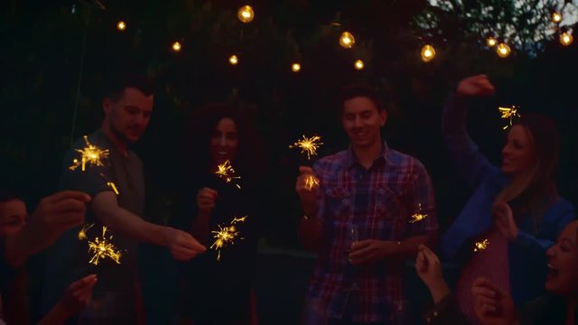 Friends dancing with sparklers 