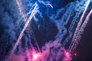 Explosive and colorful holiday fireworks at night sky.
