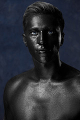 Fototapeta na wymiar a man in black make-up. portrait in dark paint. Art photography portrait