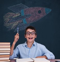 student with idea expression and rocket on the blackboard
