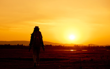 Female tourists with backpacks Traveling at sunset

