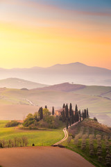 A Farmhouse near San Quirico d'Orcia with green hills and cypresses.