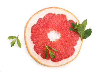 Juicy grapefruit pieces with fresh mint on the white background