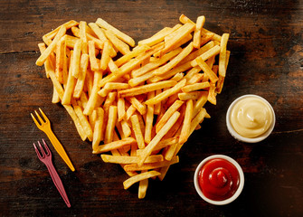 Heart shaped serving of French Fries with dips
